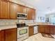 Kitchen with stainless steel appliances, wood cabinets and tile backsplash at 725 Ashworth Overlook Dr # C, Apopka, FL 32712