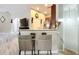 Living area featuring bar seating and connecting stairway and kitchen at 725 Ashworth Overlook Dr # C, Apopka, FL 32712