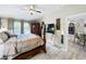 Main bedroom with a ceiling fan, wood floors, and an ornate wardrobe adding character to the home's interior at 725 Ashworth Overlook Dr # C, Apopka, FL 32712