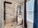 A modern bathroom shower with a rainfall showerhead, glass door, and decorative tile, offering a spa-like experience at 725 Ashworth Overlook Dr # C, Apopka, FL 32712
