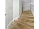 Carpeted stairway with white railings leading to the upper level of the home at 725 Ashworth Overlook Dr # C, Apopka, FL 32712