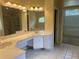 Primary bathroom with large mirror, double sinks, and a garden tub at 8012 Old Town Dr, Orlando, FL 32819