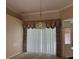 Dining room with window views, decorative curtains, and a chandelier at 8012 Old Town Dr, Orlando, FL 32819