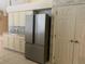 Modern kitchen features stainless steel fridge, light cabinets and tile backsplash at 8012 Old Town Dr, Orlando, FL 32819