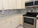 Close-up of the kitchen featuring stainless steel appliances and ample storage at 8012 Old Town Dr, Orlando, FL 32819