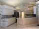 Well-lit kitchen featuring ample counter space and modern stainless steel appliances at 8012 Old Town Dr, Orlando, FL 32819