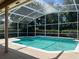 Screened pool with hedges surrounding the enclosure at 8012 Old Town Dr, Orlando, FL 32819