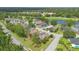 Expansive aerial view showcasing a lush residential area with pond and golf course views at 849 Bentley Green Cir, Winter Springs, FL 32708