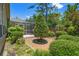 This backyard setting includes lush landscaping, a brick patio, and a screened in porch at 849 Bentley Green Cir, Winter Springs, FL 32708