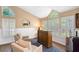 Stylish bar area featuring a wood bar, ample natural light from large windows, and comfortable seating at 849 Bentley Green Cir, Winter Springs, FL 32708