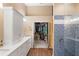 Bathroom featuring white cabinets, a walk in shower, and wood look flooring at 849 Bentley Green Cir, Winter Springs, FL 32708