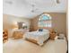 Bedroom with a bed, dresser, stained glass window, and neutral colored walls at 849 Bentley Green Cir, Winter Springs, FL 32708