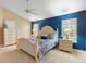 Inviting bedroom with bright blue accent wall, comfortable white furniture and bedding at 849 Bentley Green Cir, Winter Springs, FL 32708