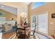 Charming dining area featuring a decorative chandelier, round table, and ample natural light from large windows at 849 Bentley Green Cir, Winter Springs, FL 32708