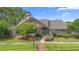Beautiful home exterior with brick facade, mature landscaping, and green lawn at 849 Bentley Green Cir, Winter Springs, FL 32708