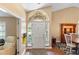 Bright foyer with hardwood flooring, arched window and front door at 849 Bentley Green Cir, Winter Springs, FL 32708
