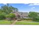 Beautiful home with brick accents, lush landscaping, and a welcoming entrance under a clear sky at 849 Bentley Green Cir, Winter Springs, FL 32708