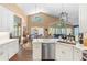 Open concept kitchen with custom cabinets, stainless appliances, a bar counter, and views into dining and living area at 849 Bentley Green Cir, Winter Springs, FL 32708