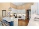 Open-concept kitchen features white cabinets, stainless appliances, and a center island at 849 Bentley Green Cir, Winter Springs, FL 32708