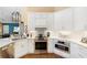 Bright kitchen boasts white cabinetry, stainless steel appliances, and ample counter space at 849 Bentley Green Cir, Winter Springs, FL 32708