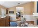 Stylish bar area with wood cabinets and an open view into the living room with a cozy fireplace at 849 Bentley Green Cir, Winter Springs, FL 32708