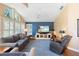 Living room with bright blue accent wall, large windows and shutters, and comfortable furniture at 849 Bentley Green Cir, Winter Springs, FL 32708