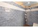 Close up of tiled shower featuring blue subway tile and a rainfall shower head at 849 Bentley Green Cir, Winter Springs, FL 32708