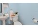 Powder room with pedestal sink, and blue walls at 901 E Pine St # 2, Orlando, FL 32801