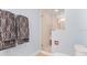 Clean bathroom with a glass door shower, neutral tile, and black and white patterned hand towels at 901 E Pine St # 2, Orlando, FL 32801