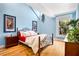 Bright bedroom with vaulted ceiling, wooden floors, a metal frame bed, and jazz artwork at 901 E Pine St # 2, Orlando, FL 32801