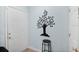 Stylish entryway with decorative tree art, stool, and neutral wall color at 901 E Pine St # 2, Orlando, FL 32801