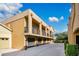 Apartment building featuring private balconies, individual garages, and a neatly landscaped yard at 901 E Pine St # 2, Orlando, FL 32801