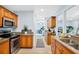 Modern kitchen showcasing stainless steel oven and ample wood cabinets at 901 E Pine St # 2, Orlando, FL 32801