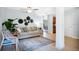 Open-concept living area with light hardwood floors, stylish furnishings, and an adjacent dining space at 901 E Pine St # 2, Orlando, FL 32801