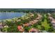 Scenic aerial view of lakeside homes with lush landscaping and private docks on a sunny day at 9142 Southern Breeze Dr, Orlando, FL 32836