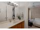 Bathroom with a vanity area, view into bedroom, and neutral color palette at 9142 Southern Breeze Dr, Orlando, FL 32836