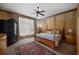 Bedroom featuring four-poster bed, ceiling fan, and natural light from a large window at 9142 Southern Breeze Dr, Orlando, FL 32836