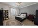 Bedroom featuring a patterned accent wall, a ceiling fan, and a neutral color palette at 9142 Southern Breeze Dr, Orlando, FL 32836