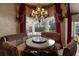 Breakfast nook with backyard views, chandelier and custom window treatments at 9142 Southern Breeze Dr, Orlando, FL 32836