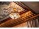 Close-up of an ornate ceiling featuring an elegant chandelier and gold accents at 9142 Southern Breeze Dr, Orlando, FL 32836