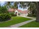 Beautiful home featuring a lush green lawn, mature landscaping, and a three-car garage at 9142 Southern Breeze Dr, Orlando, FL 32836