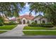 Beautiful single-story home with a well-manicured lawn and vibrant landscaping at 9142 Southern Breeze Dr, Orlando, FL 32836
