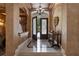 Grand foyer with decorative tile flooring, a chandelier, and an ornate console table at 9142 Southern Breeze Dr, Orlando, FL 32836