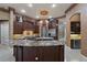 Gourmet kitchen with custom cabinetry, granite countertops, stainless steel appliances and designer chandelier at 9142 Southern Breeze Dr, Orlando, FL 32836