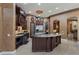 Gourmet kitchen with custom cabinetry, granite countertops, stainless steel appliances and designer chandelier at 9142 Southern Breeze Dr, Orlando, FL 32836