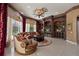 Elegant living room with custom built-ins, decorative ceiling, and large windows overlooking the landscaped yard at 9142 Southern Breeze Dr, Orlando, FL 32836