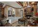 Elegant living area with a fireplace, detailed ceiling, and view into the foyer at 9142 Southern Breeze Dr, Orlando, FL 32836