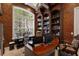 A home office featuring built-in bookshelves, a large window, and a work desk at 9142 Southern Breeze Dr, Orlando, FL 32836