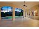 Large screened-in patio with grand pillars leading to the pool, and a view of the sunset in the distance at 9142 Southern Breeze Dr, Orlando, FL 32836