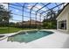 Screened-in pool with two small waterfalls and an attached spa, with a neighboring house visible through the screen at 9142 Southern Breeze Dr, Orlando, FL 32836